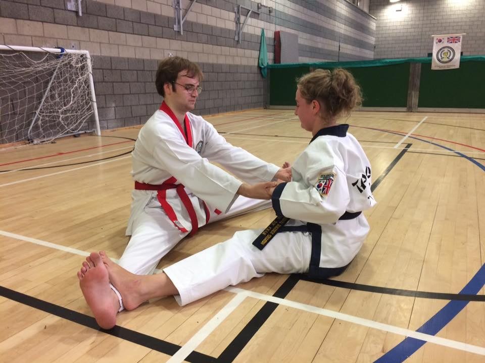 Two students practising stretching techniques