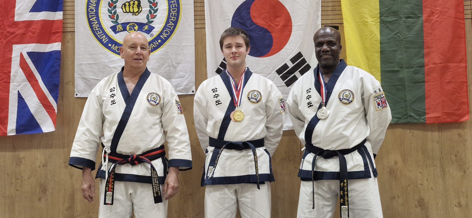 Three of our members at the 44th Nationals, with the winner in the middle wearing gold and bronze medals.